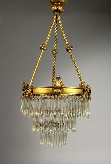 A BRASS AND CUT GLASS THREE-TIER CEILING LIGHT. 22ins