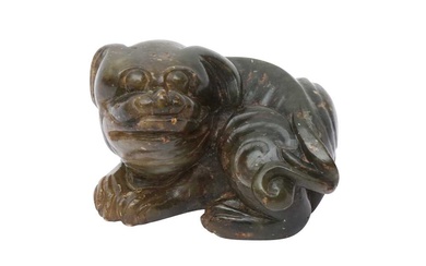 A CHINESE JADE CARVING OF A DOG 明 玉雕狗把件