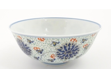 A Chinese bowl decorated with scrolling floral and foliate d...