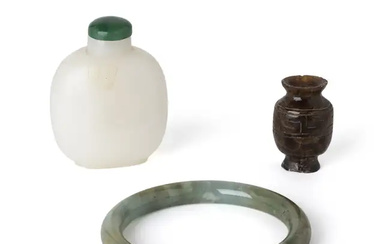 A Chinese green jade bangle and two snuff bottles 19th - 20th...