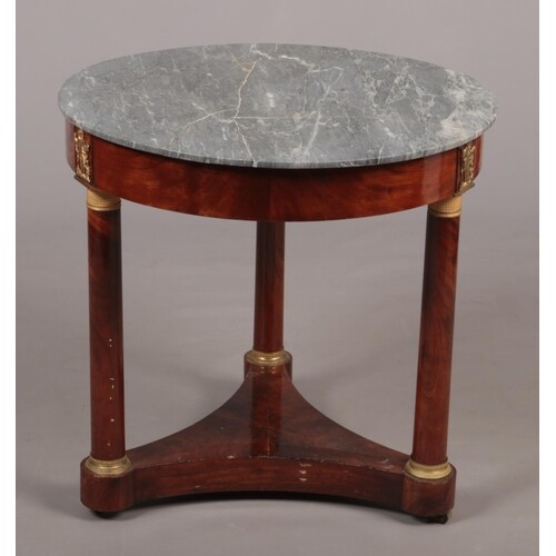 A French Empire marble top mahogany centre table of circular...