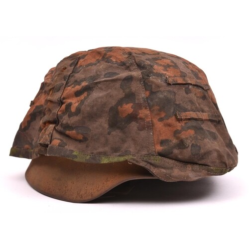 A German M40 – type steel helmet, lacking maker's mark and s...
