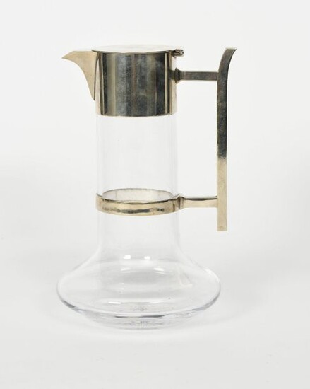 A Hukin and Heath electroplated metal and glass decanter designed by Dr Christopher Dresser, the compressed clear glass body with cylindrical neck, set with electroplated collar with short, angular spout and hinged flat cover, square section metal...