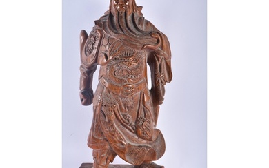 A LARGE CHINESE CARVED HARDWOOD FIGURE OF A STANDING WARRIOR...