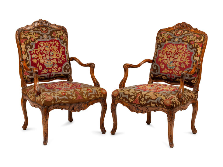 A Pair of Régence Walnut Needlepoint-Upholstered Fauteuils
