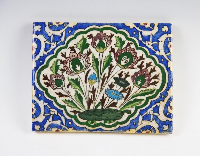 A Persian Iznik hand painted glazed fritware tile, circa 17t...