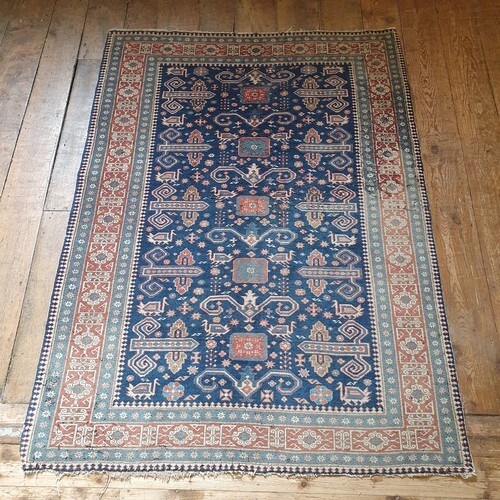 A Persian blue ground rug, main red border, centre with repe...