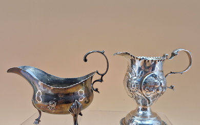 A SILVER CREAM JUG BY CHARLES HOUGHAM, LONDON 1773, EMBOSSED WITH FRUIT TOGETHER WITH A SAUCE BOAT