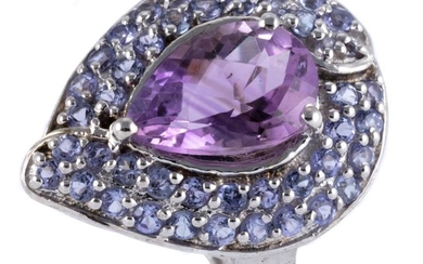 A STERLING SILVER AMETHYST COCKTAIL RING; drop shape mount centring a chequerboard pear cut amethyst to surround of round cut amethy...