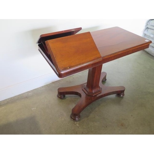 A Victorian mahogany adjustable reading table on a quatrefoi...