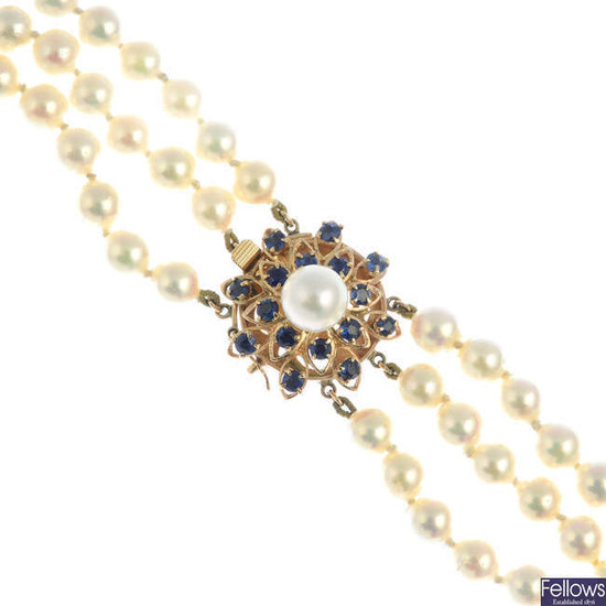 A cultured pearl three-row necklace, with sapphire and cultured pearl cluster clasp.