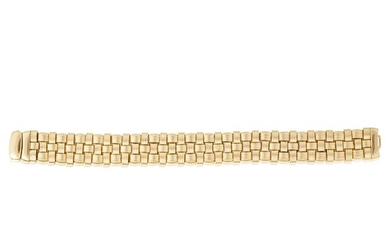 A fourteen karat gold bracelet designed as three rows...