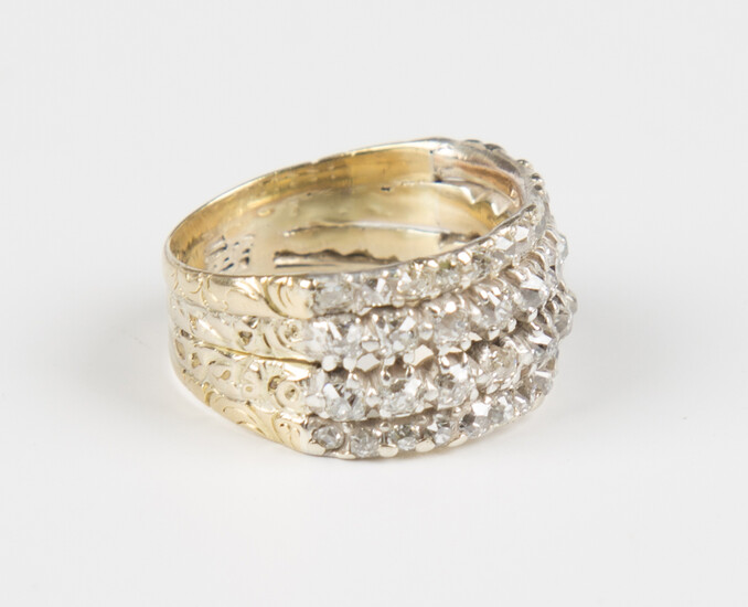 A gold and diamond four row ring, claw set with circular cut diamonds with engraved decoration, weig