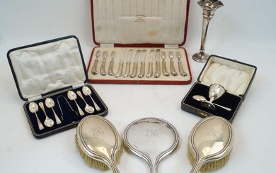 A group of silver, comprising: a cased set of six silver handled dessert knives and forks, Sheffield, 1917, Thomas Bradbury & Sons Ltd, with pistol handles; a cased christening set, comprising an egg cup and a teaspoon, Birmingham, 1921 and 1923...
