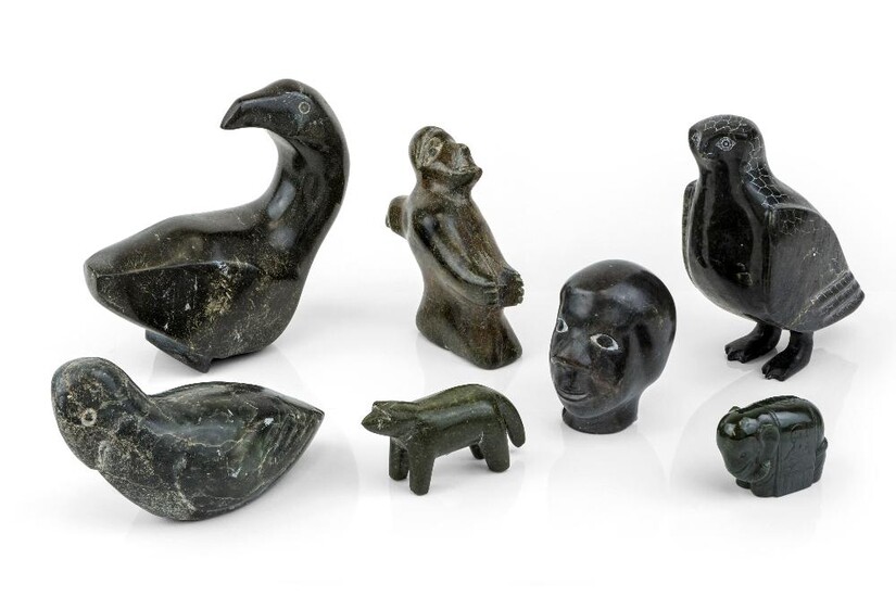 A group of six Inuit soapstone carvings, late 20th century, comprising: three birds, a figure and bird, a head and a bear, 16cm high and smaller; together with a green hardstone model of an elephant, 3.7cm high (7) Provenance: The Geoffrey and Fay...