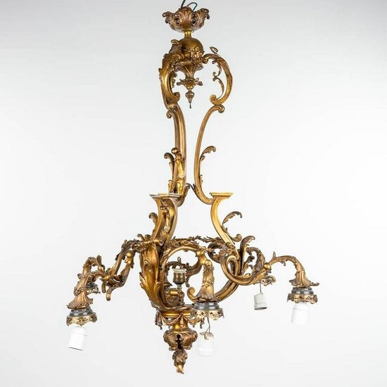 A large chandelier made of bronze in Louis XV style and