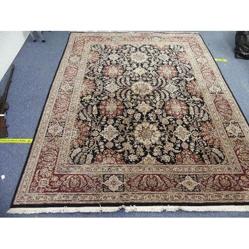A large hand-knotted Persian-style wool Rug, black ground wi...