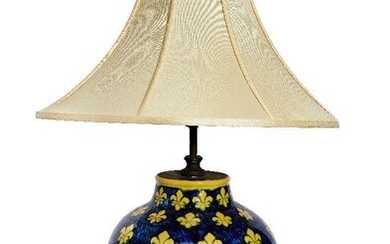 A large modern Italian glazed pottery table lamp, of baluster form decorated with fleur-de-lys, 41cm high excluding fitment It is the buyer's responsibility to ensure that electrical items are professionally rewired for use.