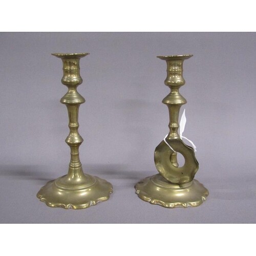 A pair of 18c brass petal based candlesticks, one inscribed ...