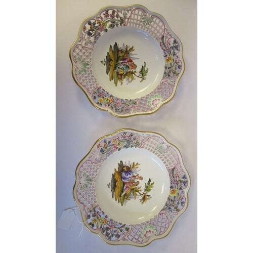 A pair of 20thC Meissen porcelain plates, each featuring a c...