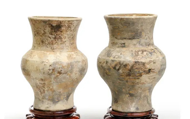A pair of Chinese painted earthenware jars, hu Han dynasty Each raised...