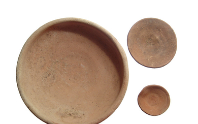A pair of Egyptian offering dishes and a Roman bowl
