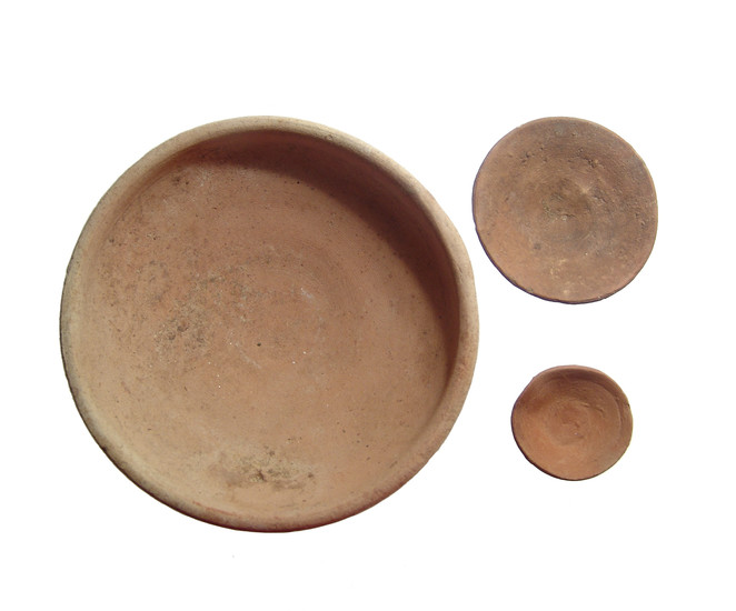 A pair of Egyptian offering dishes and a Roman bowl