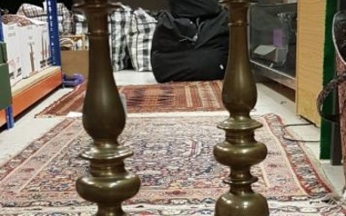 A pair of brass ecclesiastical style pricket candlesticks on...