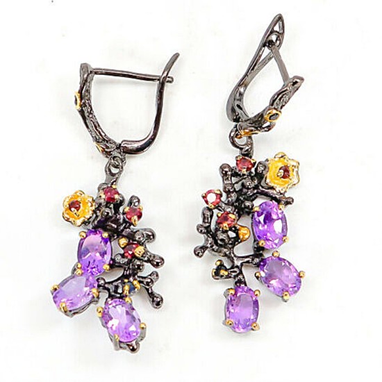 A pair of ear pendants each set with numerous oval and circular-cut amethysts, sapphires and rhodolite garnets, mounted in black rhodium and gold plated silver.