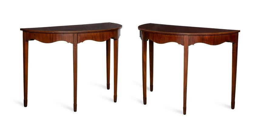 A pair of inlaid mahogany demilune side tables