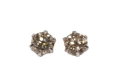 A pair of single stone diamond stud earrings