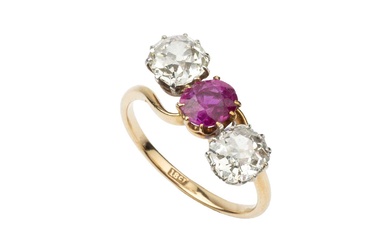 A ruby and diamond three stone ring, the central oval...