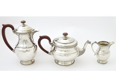 A three piece silver tea set comprising teapot, hot water po...