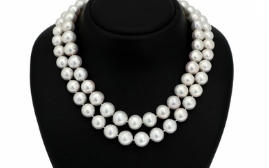 SOLD. A two-string pearl necklace set with numerous cultured South Sea pearls, clasp set with...