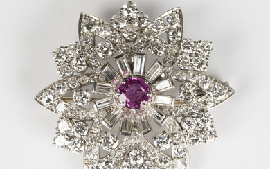 A white gold, diamond and ruby brooch in a floral shaped design, claw set with a central circular cu