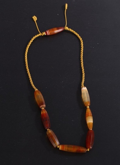 AN ARCHAIC WESTERN ASIATIC AGATE BEAD NECKLACE