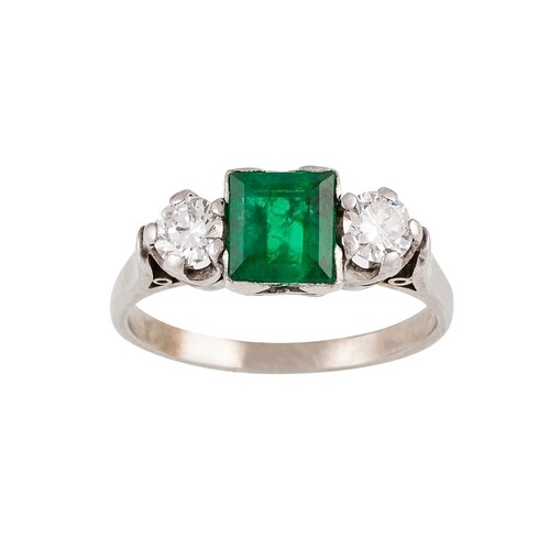 AN EMERALD AND DIAMOND THREE STONE RING, the square cut emer...