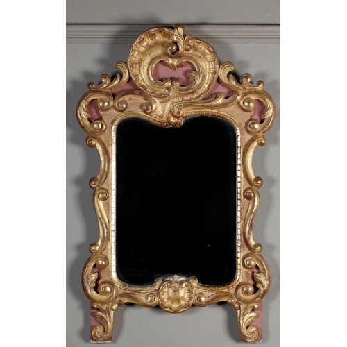 AN ITALIAN GILTWOOD WALL MIRROR in 18th century style, carve...