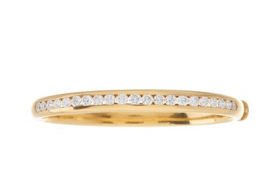 An 18ct gold brilliant-cut diamond line bangle bracelet, est...