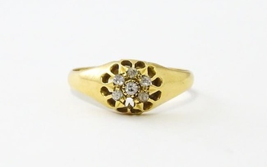 An 18ct gold ring set with 6 diamonds. Ring size approx L Please Note - we do not make reference to