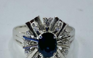 An 18ct white gold sapphire and diamond ring Central...