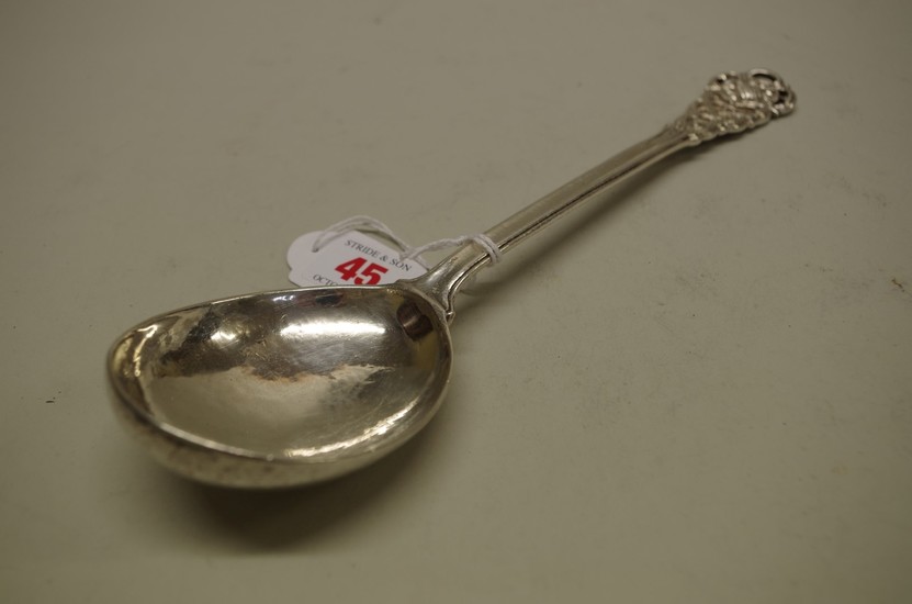 An Arts & Crafts planished silver serving spoon, by Omar...