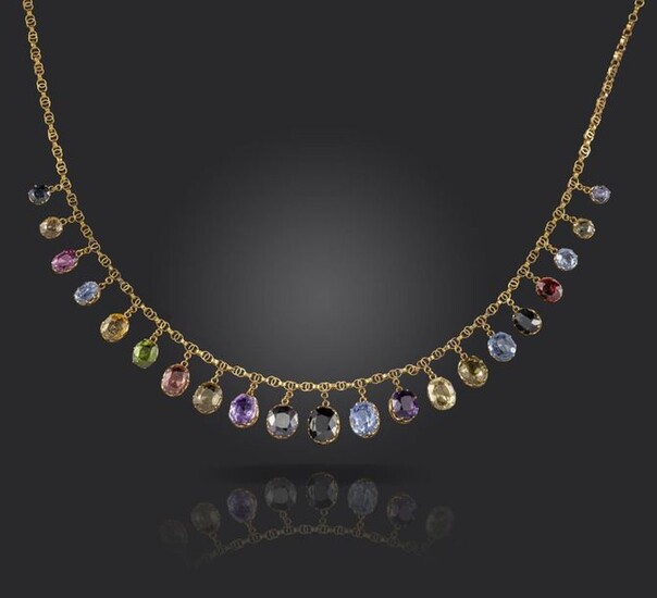 An Edwardian gold fringe necklace, set with sapphires, garnets, amethysts and zircons in yellow gold collets on fancy-link yellow gold necklace, 38cm long