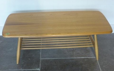 An Ercol Golden Dawn blonde elm coffee table with under tier...