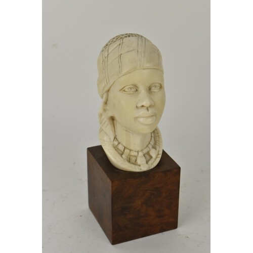 An early 20th century African Ivory bust on walnut plinth, w...