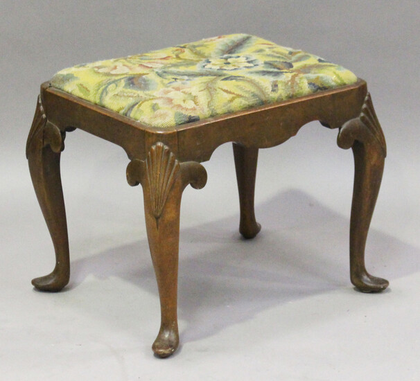 An early 20th century Queen Anne style walnut stool, the drop-in woolwork seat on scallop shell carv