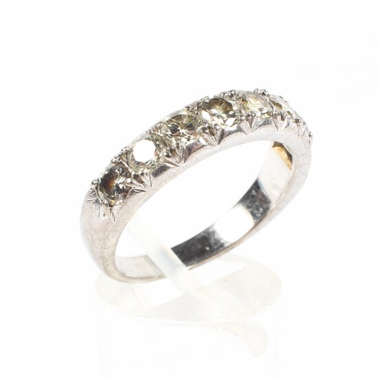 An early 20th century white metal half eternity diamond ring set with eight clawset brilliant cut