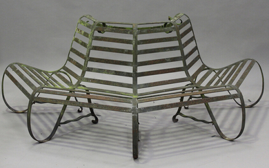 An early 20th century wrought iron tree trunk surround bench of slatted octagonal form, height 74cm