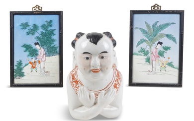CHINESE PORCELAIN PILLOW OF A KNEELING CHILD AND A PAIR OF CANTON FAMILLE ROSE ENAMEL FRAMED PICTURES Length of boy: 12 in. (30.5 cm.), Sight size of pictures: 9 x 5 3/4 in. (22.9 x 14.6 cm.)
