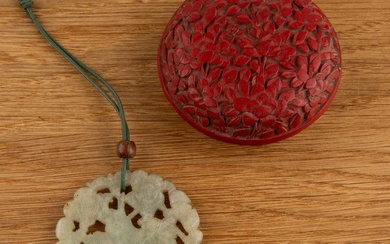Cinnabar lacquer carved circular box and a jade pendant Chinese...
